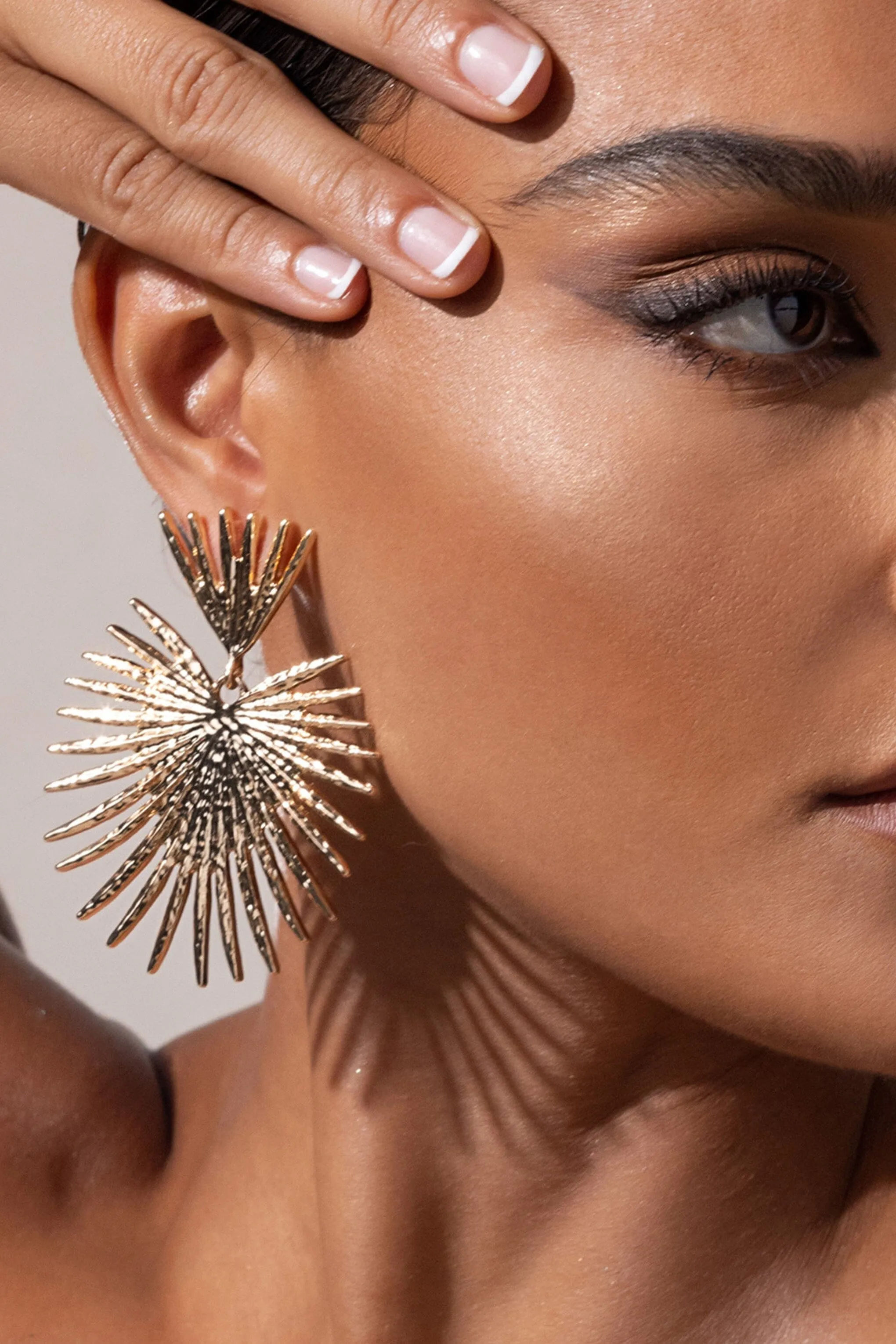 GOLD STARBURST DROP EARRINGS Gloria Lanvin