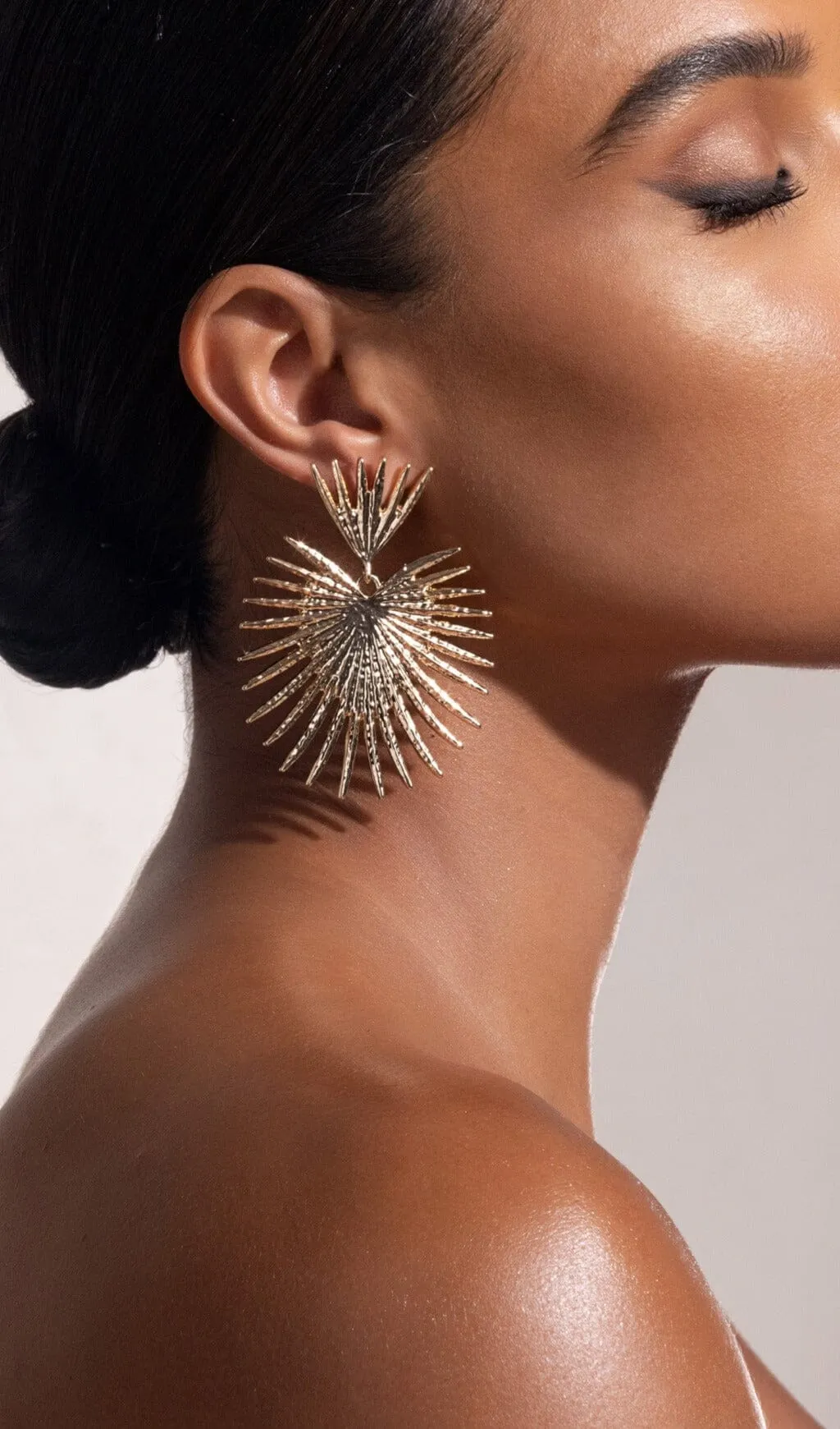 GOLD STARBURST DROP EARRINGS Gloria Lanvin