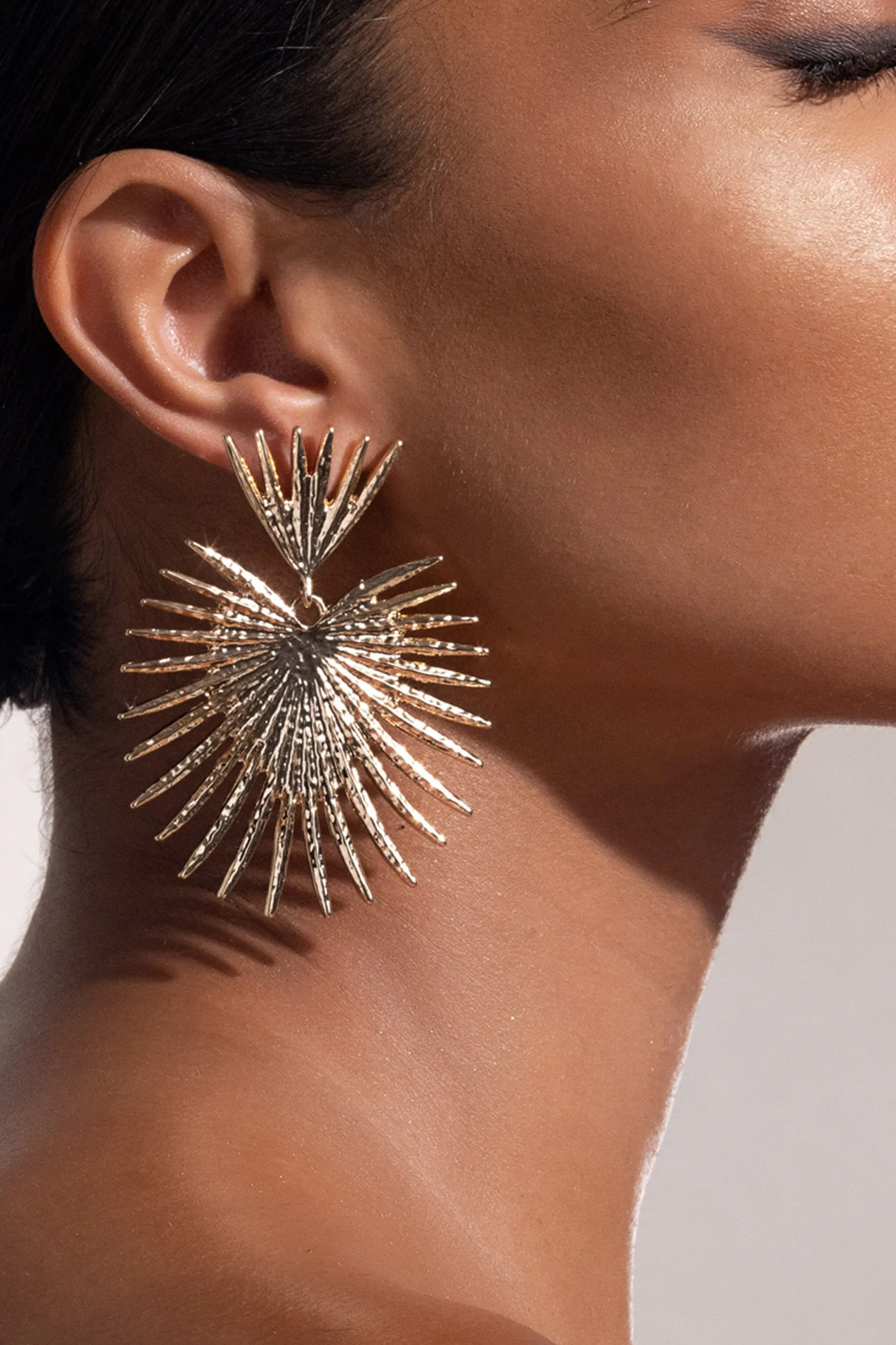 GOLD STARBURST DROP EARRINGS Gloria Lanvin